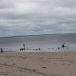 Standup paddleboard ved en flodbred i Amazonas nær en lille lokal kirkegård på